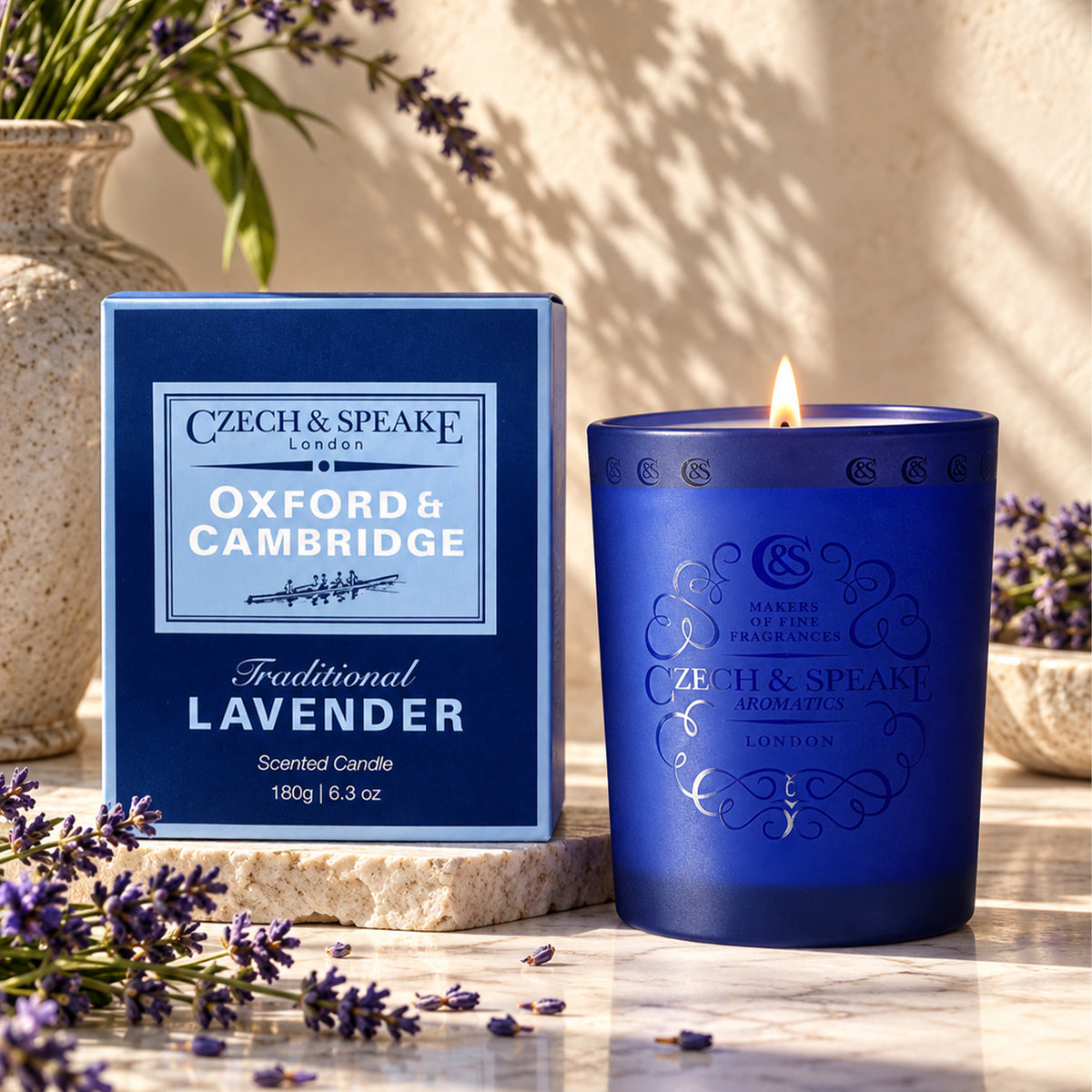 Czech & Speake Oxford & Cambridge Candle in a decorative glass jar with a lit wick and elegant packaging.