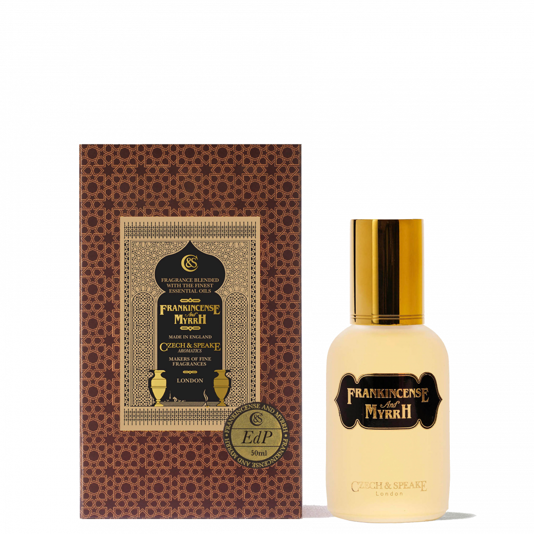 A clear glass bottle of Frankincense and Myrrh eau de parfum with a brushed steel cap.